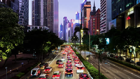 Evening-Rush-Hour-on-Gloucester-Road,-Hong-Kong-with-Illuminated-Skyscrapers