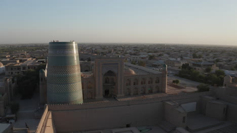 Aerial-drone-point-of-the-Itchan-Kala-and-Alla-Kouli-Khan-Madrasa-at-the-old-walled-city-of-Khiva-in-Uzbekistan