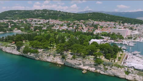 Wide-aerial-of-green-park-area-and-cliffs-by-harbor-in-Split,-Croatia