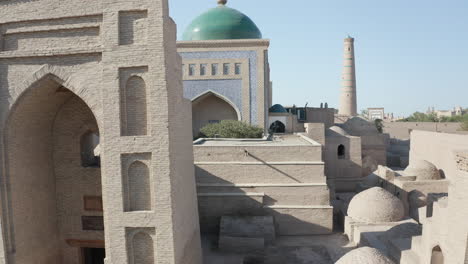 Aerial-drone-point-of-the-Itchan-Kala-and-Islam-Khodja-minaret-at-old-walled-city-of-Khiva-in-Uzbekistan