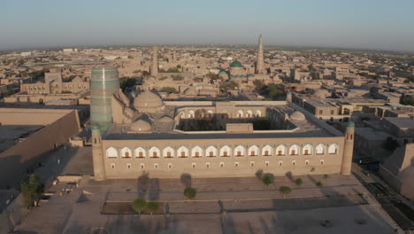 Aerial-drone-point-of-the-Itchan-Kala-and-Alla-Kouli-Khan-Madrasa-at-the-old-walled-city-of-Khiva-in-Uzbekistan