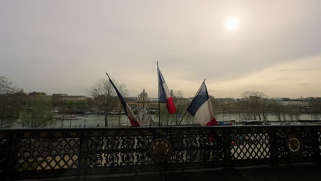 French-flags-moving-in-the-wind,-outside-the-Louvre-Museum,-Paris,-France