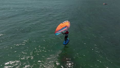 Wing-foil-wind-surfer-riding-the-calm-sea-water-of-The-Mediterranean-Sea