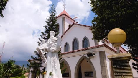 Historical-landmark-of-Roman-Catholic-Motael-Church-with-religious-statue-in-capital-city-of-Dili,-Timor-Leste,-Southeast-Asia