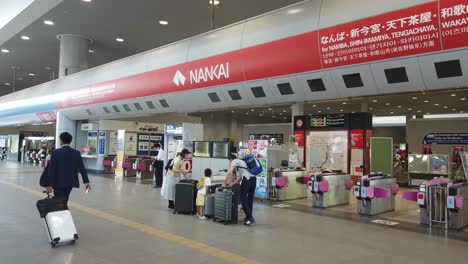 Turnstile-Gates-at-Nankai-Train-Line,-Osaka-Japan-Airport-Railway,-People-Travel-in-Asia