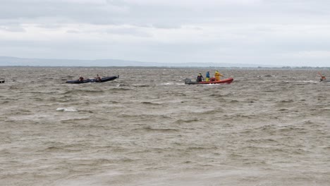 Currach-boats-and-support-vessels-cross-galway-bay,-static