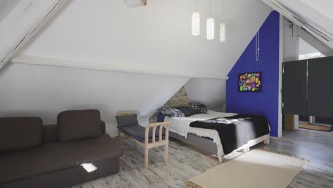 Slow-revealing-shot-of-a-clean-child's-bedroom-with-sofas-in-the-corner