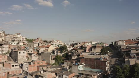 Slow-forward-drone-flyover-destroyed-old-buildings-in-Favela-of-Sao-Paulo-during-sunny-day-with-blue-sky