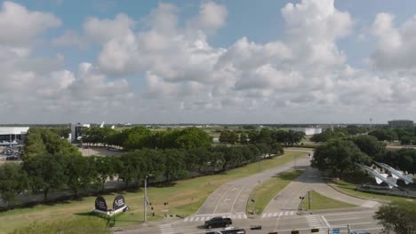 Aerial-drone-view-panning-right-to-left-of-the-entrance-to-Space-Center-Houston-on-NASA-road-1-in-Houston-Texas