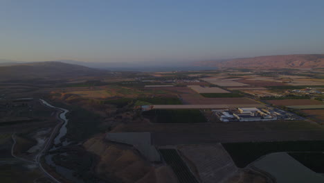 PullBack-at-sunset-over-the-Jordan-Valley,-the-Jordan-River-and-the-southern-Sea-of-Galilee-in-the-background