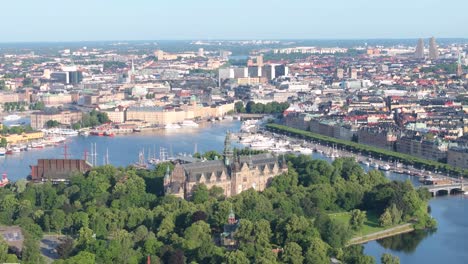 Nordic-Museum-and-Vasa-Museum-on-island,-aerial-reveal-of-central-Stockholm,-Sweden