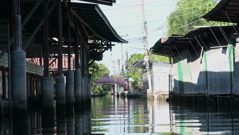 Closed-stalls-along-the-canal-of-Damoen-Saduak-Floating-Market,-Thailand