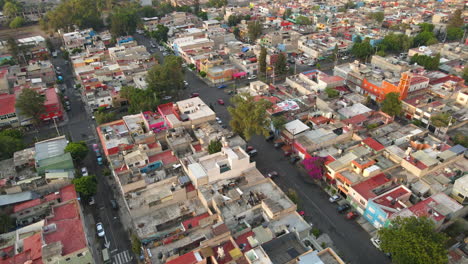 Aerial-fly-over-Salvador-Diaz-neighborhood-house-buildings-with-cars-driving-in-road-traffic