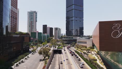 Establishing-shot,-drone-flying-through-downtown-Mexican-city,-daytime,cityscape