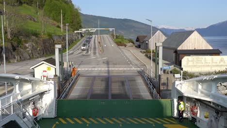 Boom-closing-and-ferry-preparing-for-departing-Hella-ferry-pier-in-Sognefjorden-Norway---First-person-view-from-onboard-the-ferryboat