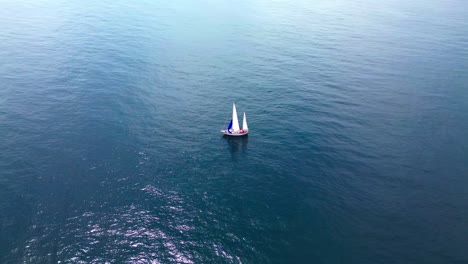 aerial-view-of-sailing-ship-in-the-vast-blue-ocean,-4k