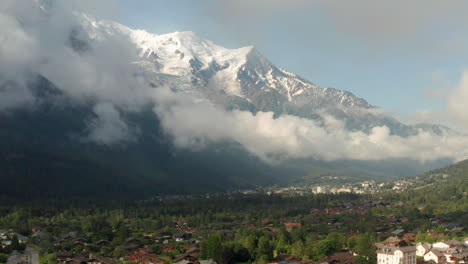 Rising-aerial-shot-of-Mont-Blanc-towering-over-Chamonix-village-France