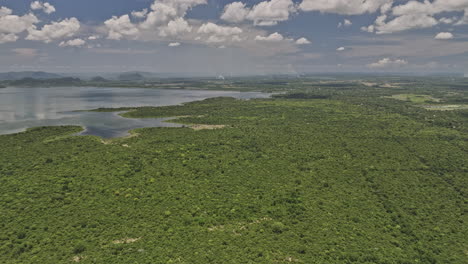 Bogahawewa-Sri-Lanka-Aerial-v4-flyover-lakeside-capturing-serene-nature-landscape-of-Lunugamvehera-Reservoir-National-Park-and-water-reflection-in-hot-summer---Shot-with-Mavic-3-Cine---April-2023