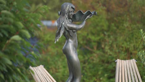 A-bronze-statue-of-a-beautiful-young-woman-in-the-park