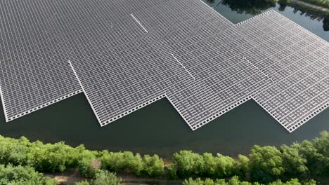 Sideways-aerial-view-of-large-solar-panel-array-on-a-lake-in-New-Jersey