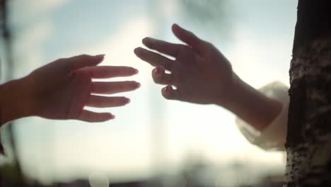 The-hands-of-two-people-tend-to-touch-one-another,-emotional-love,-togetherness,-human-relation,-separation-concept