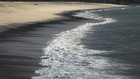 Waves-gently-roll-onto-the-sandy-beach