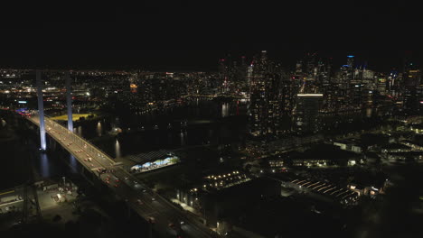 Melbourne-city-view-at-night-from-a-drone-certified-drone-operator-Bolte-Bridge-Victoria-Australia-traffic-docklands-CBD-with-peak-hour-traffic-twin-towers-gateway-to-Melbourne-north