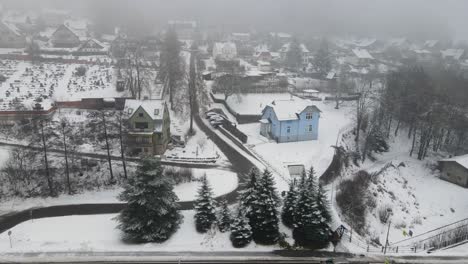 Revealing-drone-shot-of-a-pension-in-the-snow-in-Pec-Pod-Snezkou,-Czech-Republic