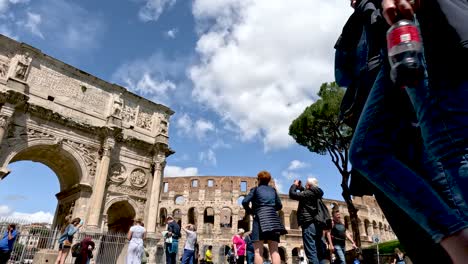 Tourists-visiting-and-taking-pictures-of-the-Colosseum-and-Arch-of-Constantine-in-Rome