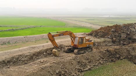 Digging-excavator-bulldozer-on-a-project-beside-farmland-in-Bangladesh