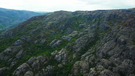Rocky-hillslope-of-rio-tera-canyon-and-exposed-stone-covered-in-greenery