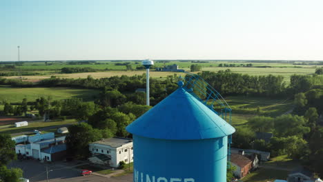 Aerial-Ascending-View-of-Two-Water-Towers-in-Winger,-Minnesota