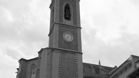 Santa-Maria-Parish-Church-Bell-Tower,-Sagunto,-Spain-in-Black-and-White-Low-Angle