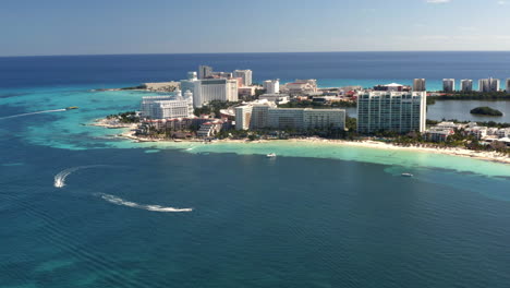 Cancun-city-skyline-on-carribean-coast-with-cruising-boats-and-hotels