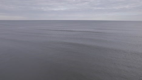 Drone-Flying-Over-Ocean---4K-Beach-Shot-on-Overcast-Day