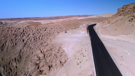 Aerial-of-a-car-in-the-road-in-Atacama-desert,-Chile---forward,-drone-shot