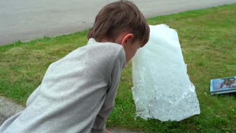 Museum-employee-shows-child-piece-of-real-glacial-ice-at-Fjaerland-Glacier-Museum-in-Norway