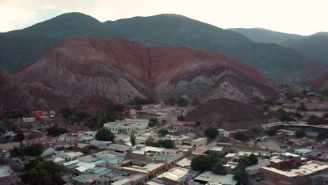 Town-of-Purmamarca-and-colored-mountains-in-Argentina,-aerial-pull-out