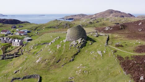 Tilting-drone-shot-of-the-'Dun-Carloway-Broch'-on-the-west-coast-of-the-Isle-of-Lewis,-part-of-the-Outer-Hebrides-of-Scotland