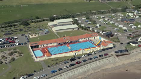 An-aerial-view-of-Stonehaven-outdoor-swimming-pool-on-a-sunny-summer-afternoon,-Aberdeenshire,-Scotland,-UK