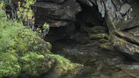 A-shallow-stream-flows-into-the-dark-rocky-cave