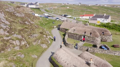 Close-up-drone-shot-of-the-Gearrannan-Blackhouse-Village-on-the-Isle-of-Lewis,-part-of-the-Outer-Hebrides-of-Scotland