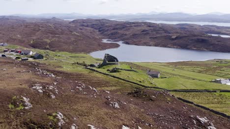 Drone-shot-circumnavigating-the-'Dun-Carloway-Broch'-on-the-west-coast-of-the-Isle-of-Lewis,-part-of-the-Outer-Hebrides-of-Scotland
