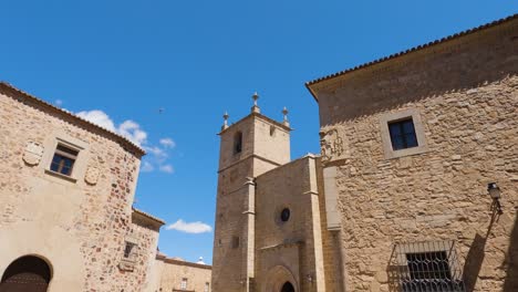 Looking-Up-At-Church-Tower-Of-Cathedral-Of-Santa-Maria-In-Cáceres-Against-Clear-Blue-Sky