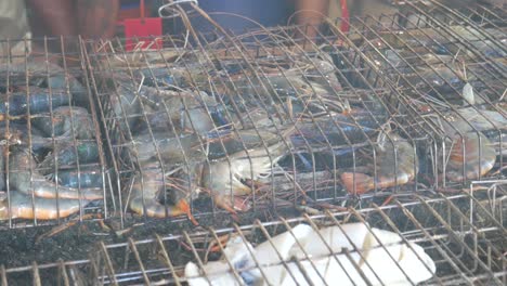 grill-cooking-river-prawns-in-metal-cage-on-hot-charcoal-in-Thailand-Asia