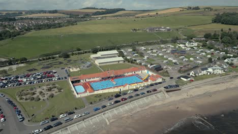 An-aerial-view-of-Stonehaven-outdoor-swimming-pool-on-a-sunny-summer-afternoon,-Aberdeenshire,-Scotland,-UK