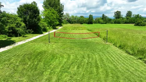 Slow-motion-dolly-shot-overhead-a-grass-volleyball-court-in-the-countryside