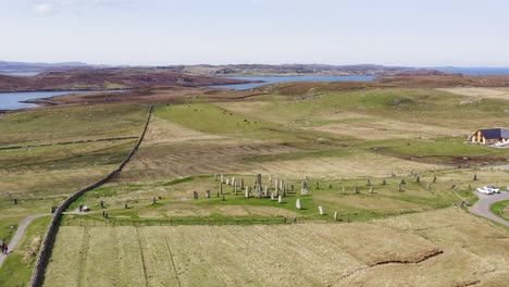 Drone-shot-circumnavigating-the-ancient-Callanish-Standing-Stones-on-the-Isle-of-Lewis,-part-of-the-Outer-Hebrides-of-Scotland