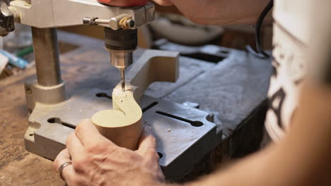 A-violin-maker-prepares-the-top-of-a-violin-by-drilling