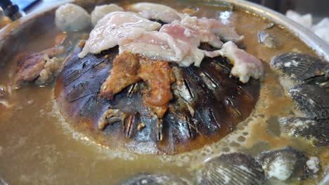 thailand-style-hotpot-with-centre-grill-cooking-pork-and-clam